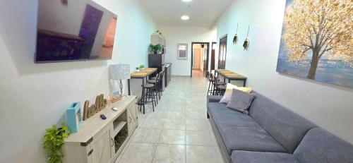 a living room with a couch and some tables and chairs at 10 MIN FROM BEACH! 4 Queen Beds in Puerto Peñasco