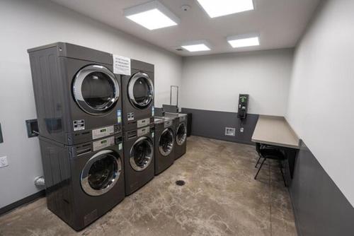 a laundry room with three washing machines and a counter at Pigeon Forge Landing RV Resort in Pigeon Forge