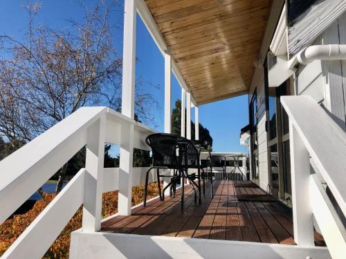 a deck with chairs on a house at The Mountain View Studio in Rangataua