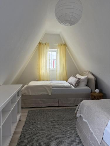 a bedroom with two beds and a window at Das Haus am Limburger Dom in Limburg an der Lahn