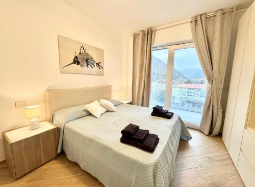 a bedroom with two beds and a window at Apartment Prestige in Finale Ligure