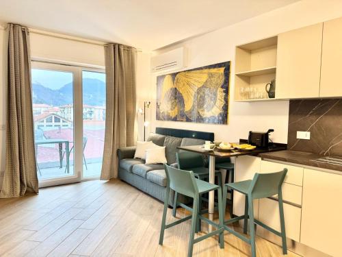 a kitchen and living room with a couch and a table at Apartment Prestige in Finale Ligure