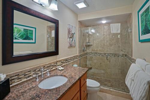 a bathroom with a sink and a shower at Secret Harbour Beach Resort in St Thomas