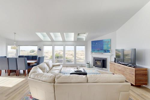 a white living room with a couch and a tv at 3 Bed 3 Bath Vacation home in Bayshore Beach Club in Waldport