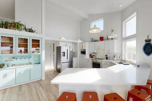 a kitchen with white and blue cabinets and a refrigerator at 3 Bed 3 Bath Vacation home in Bayshore Beach Club in Waldport
