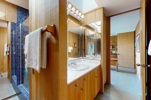 a bathroom with a sink and a large mirror at Rolling Waves Beach House in Sea Ranch
