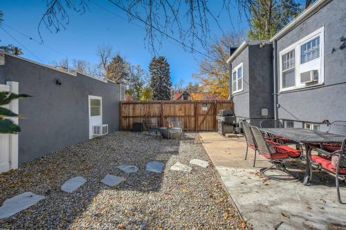 a backyard with a table and chairs next to a building at Olympic Studio - Workcation Hot Tub 4K Roku in Colorado Springs