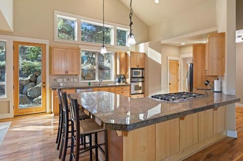 a kitchen with a large island with bar stools at Lucy Lou 30 Day Minimum in Bend