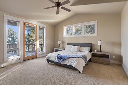 a bedroom with a bed and a ceiling fan at Lucy Lou 30 Day Minimum in Bend