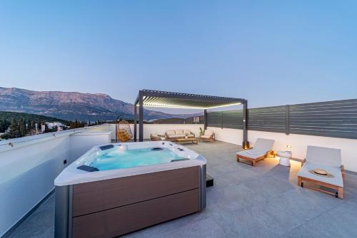 a hot tub on the roof of a house at Penthouse apartment Optimum in Korčula