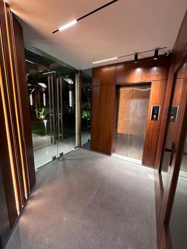 an empty hallway of a building with glass doors at Heaven Prestige Hotel in Jounieh