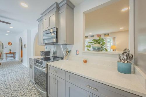 a kitchen with white cabinets and a counter top at Restful Riverside Residence in Athens
