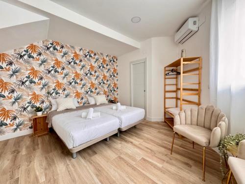 a bedroom with a large bed and a chair at Crysoyle Apartment II Barcelona Next to Camp Nou in Hospitalet de Llobregat
