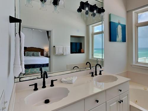 a bathroom with two sinks and a large mirror at Calle Bonita Townhomes #1714 in Pensacola Beach