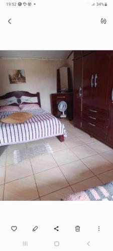 a bedroom with a bed and a dresser at Pousada Paraíso Pedacinho Do Céu 2 in Águas de Lindóia