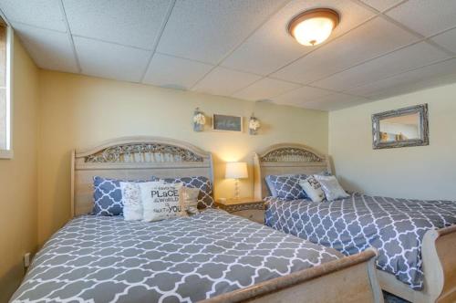 a bedroom with two beds with blue and white sheets at Red Rock Rentals in Cannonville