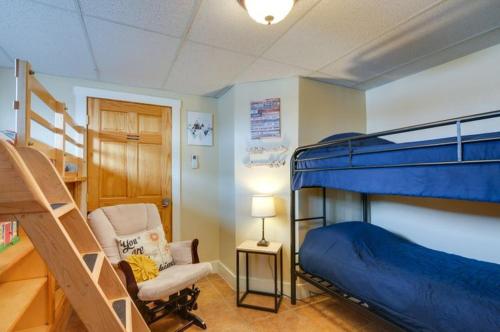 a bedroom with a bunk bed and a chair at Red Rock Rentals in Cannonville