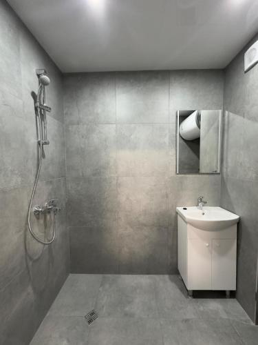 a bathroom with a shower and a white sink at Sea in Varna City