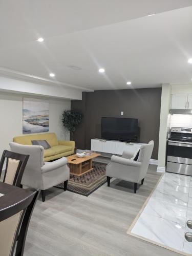 a living room with a couch and a table at Stunning Furnished 2 Bedroom 2 Washroom Basement Apartment in Brampton