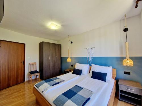 a bedroom with a large bed with a blue accent wall at Poreč SUNNY Apartment with large balcony by Villa Mihaela in Poreč