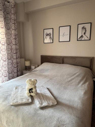 a teddy bear sitting on top of a bed at Apartment in Komotini in Komotini