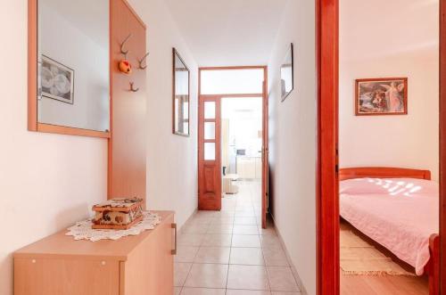 a bedroom with a bed and a table and a mirror at House Ivana in Blato