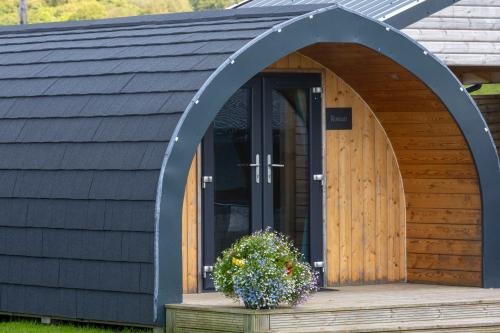 an arched entry to a building with a wooden door at Fulshaw Mill Holidays in Stewarton