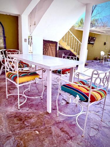 a white table and chairs sitting on a patio at La Casita Inn Bustamante in Bustamante