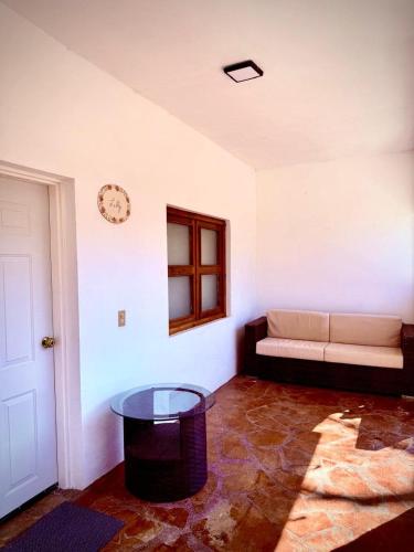 a living room with a couch and a table at La Casita Inn Bustamante in Bustamante