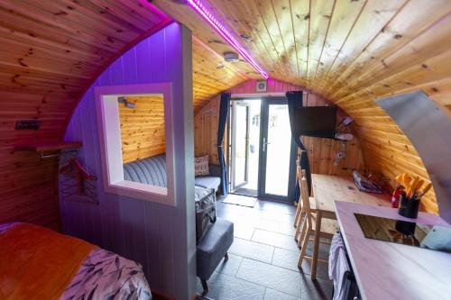 a room with purple walls and a wooden ceiling at Fulshaw Mill Holidays in Stewarton