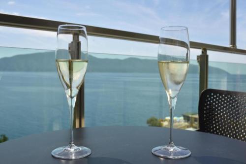 two glasses of white wine sitting on a table at Nuna Hotel & Apartments in Vlorë