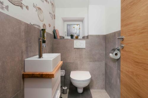 a bathroom with a white toilet and a sink at Hallstatt-Haus Elfriede in Hallstatt