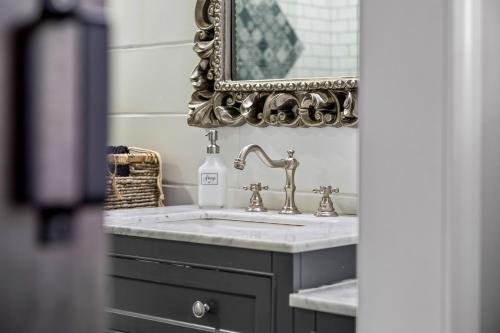 a bathroom with a sink and a mirror at Tropical Oasis- Pickleball, Pool, Hot Tub- 15 min to beach in Melbourne