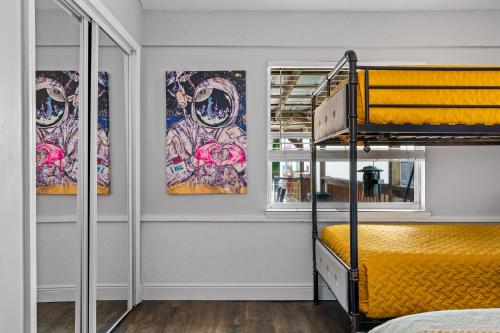 a room with a bunk bed and a window at Tropical Oasis- Pickleball, Pool, Hot Tub- 15 min to beach in Melbourne