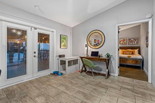 a home office with a desk and a bed at Tropical Oasis- Pickleball, Pool, Hot Tub- 15 min to beach in Melbourne