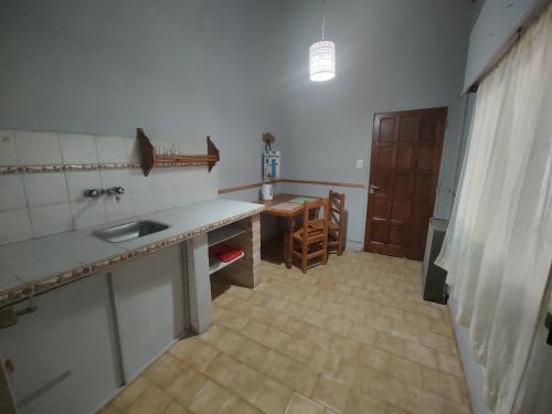 a kitchen with a sink and a counter top at La Damasca in General Roca