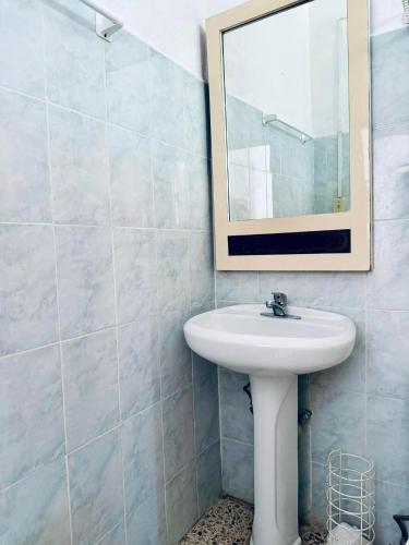 a bathroom with a sink and a mirror at La Casita Inn Bustamante in Bustamante