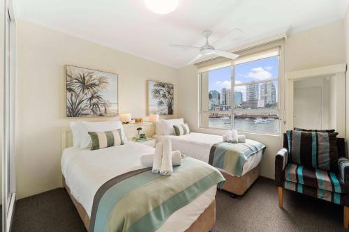 a bedroom with two beds and a window at Harbourside 10 in Sydney