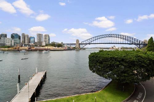 a view of a river with a bridge and a city at Harbourside 10 in Sydney