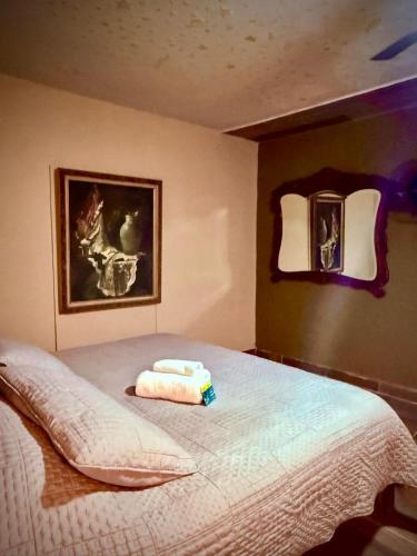 a bedroom with a bed with two towels on it at La Casita Inn Bustamante in Bustamante
