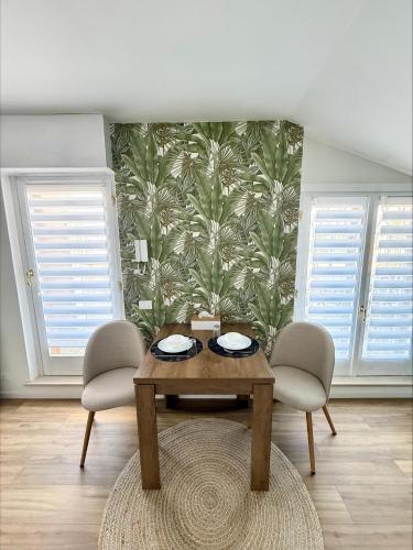 a dining room with a table and two chairs at Catullo Loft Near Verona in Dossobuono