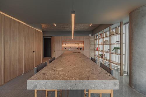 a large long table in a room with a long hallway at The Somos Loho Hotel in Medellín