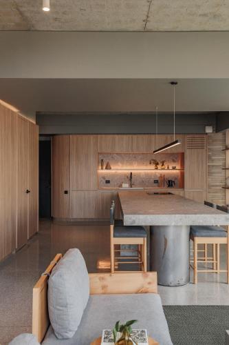 a kitchen with a large island in the middle at The Somos Loho Hotel in Medellín