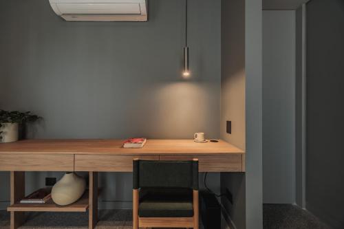 a wooden desk in a room with a chair at The Somos Loho Hotel in Medellín