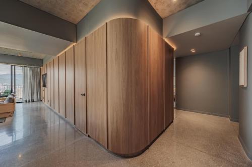 a hallway with wooden dividers in a house at The Somos Loho Hotel in Medellín