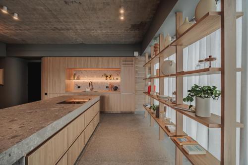 a large kitchen with wooden cabinets and a counter at The Somos Loho Hotel in Medellín
