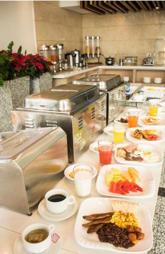 a buffet line with plates of food in a restaurant at Hotel Las Cascadas in San Pedro Sula