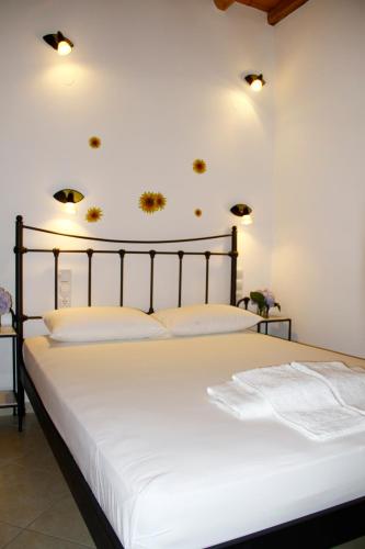 a bedroom with a large bed with white sheets at Alisachni in Serifos Chora