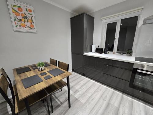 a dining room with a table and a kitchen at Shrewsbury Creations in Shrewsbury