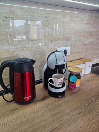 a coffee maker and a cup of coffee on a counter at Drina Lux in Loznica